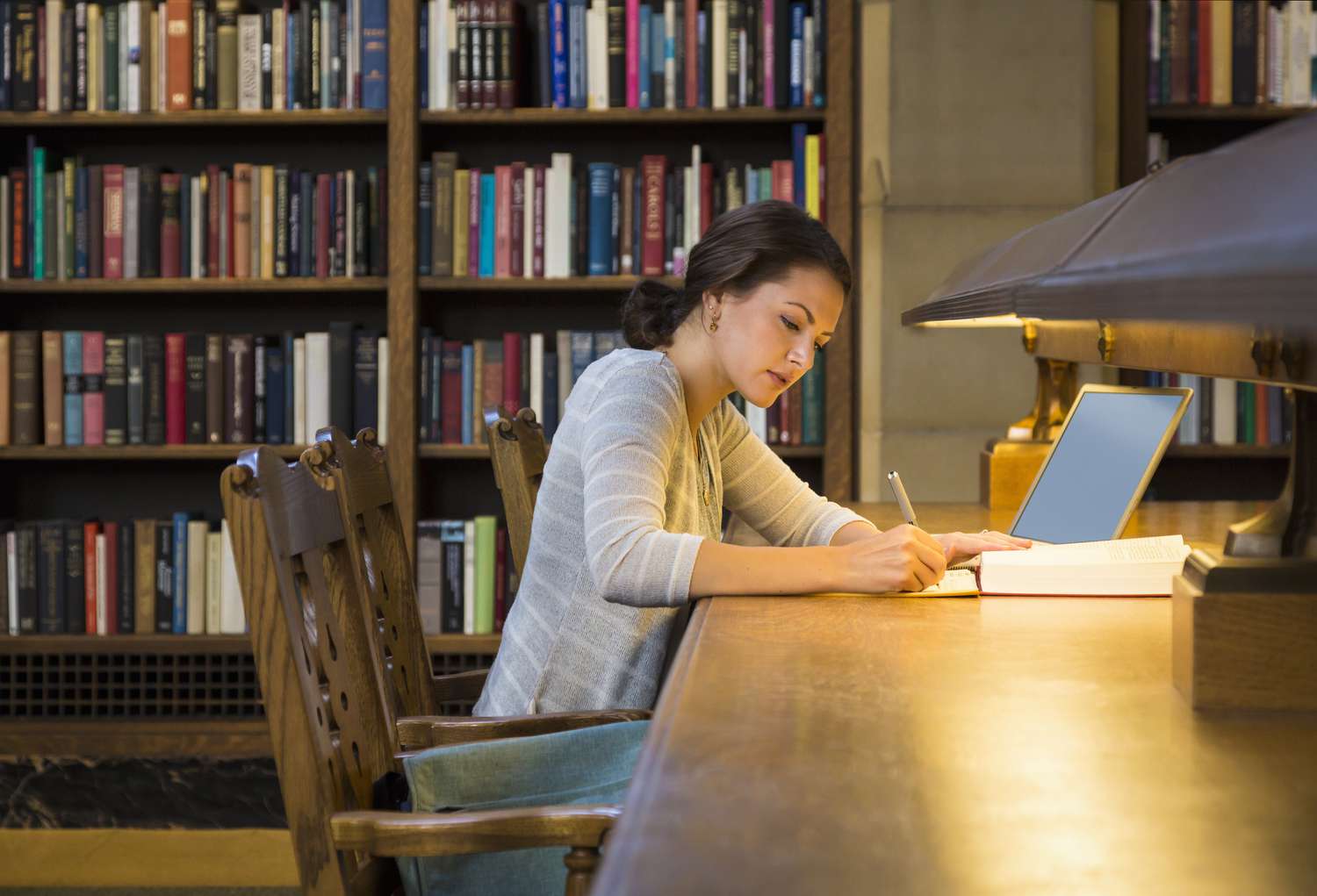 Tutor working with a student at a desk